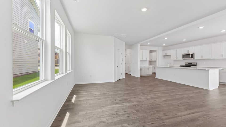 open concept living area overlooked by kitchen