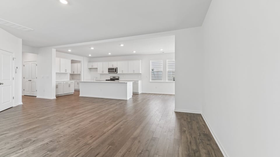 open concept living area overlooked by kitchen