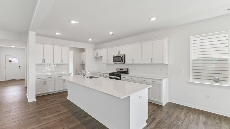 kitchen with spacious island white cabinets and quartz countertops