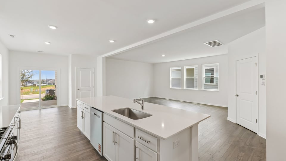 open concept living area overlooked by kitchen