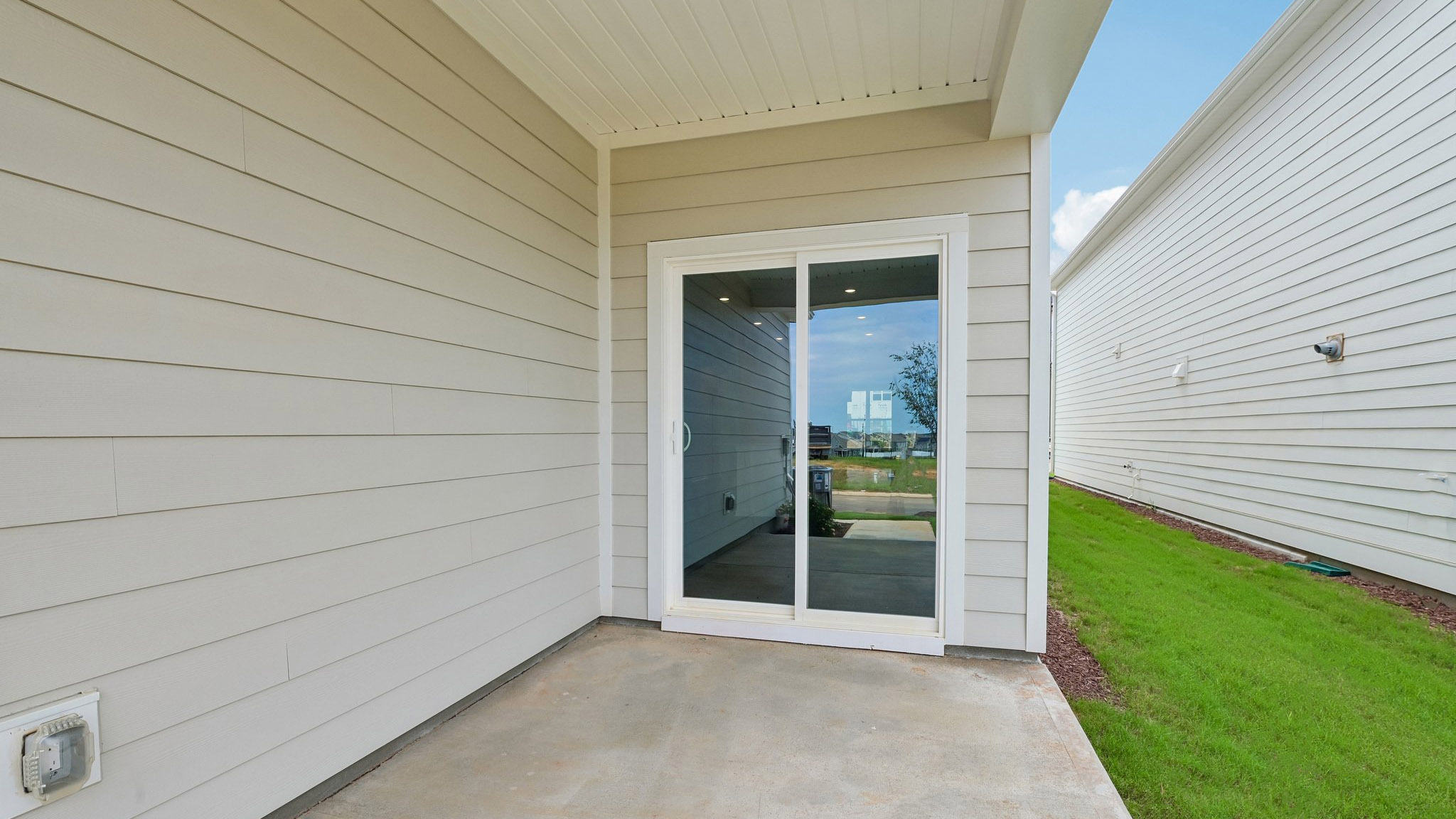 covered patio with sliding glass doors