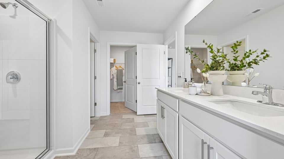 bathroom with walkin glass door shower and dual vanity