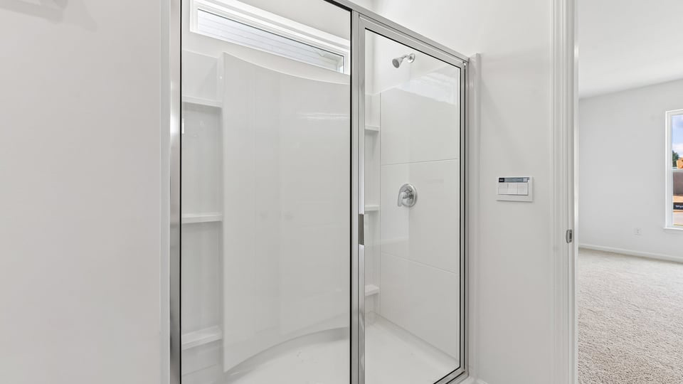 secondary bathroom with walk in shower and single vanity sink