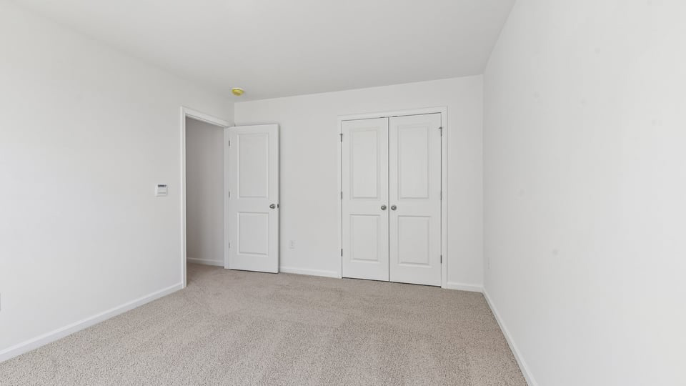 additional bedroom with window, carpeting, closet
