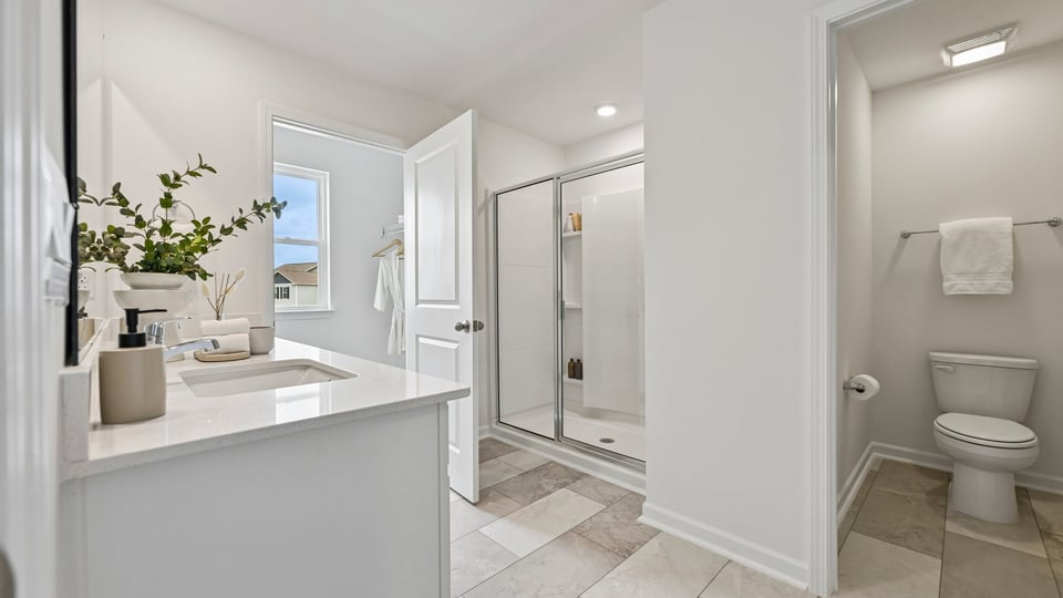 bathroom with quartz countertops and separate water closet