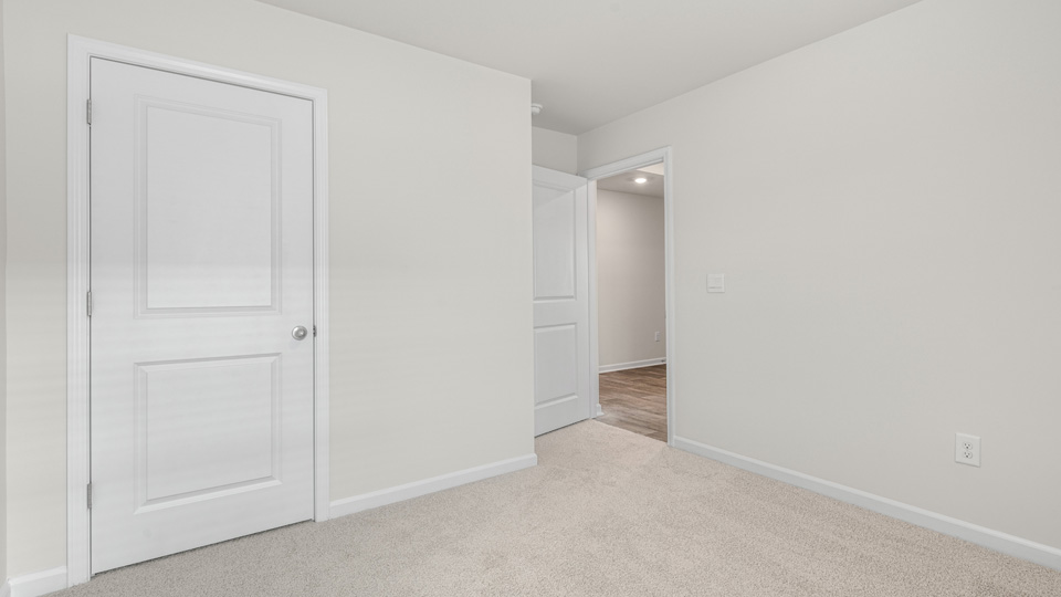 additional bedroom with window, carpeting, closet