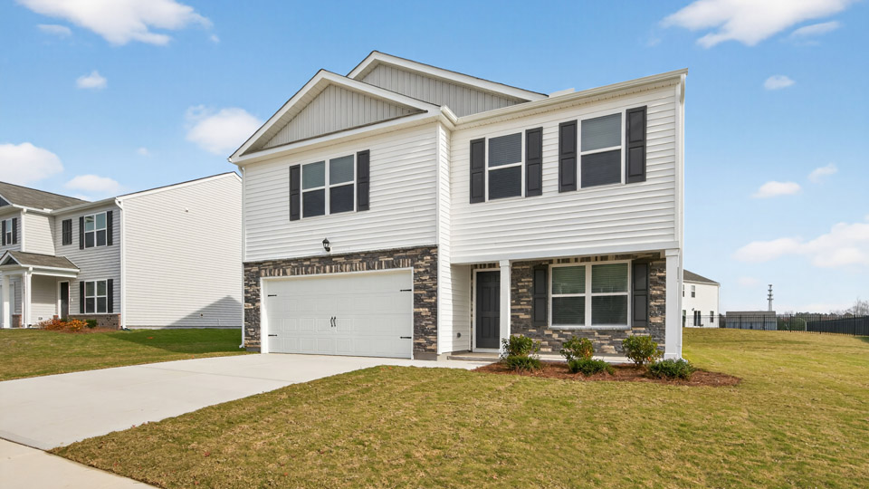 Two story home with white siding and covered porch and two-car garage