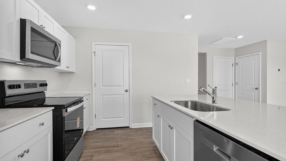 Kitchen with white cabinets and stainless steel appliances.