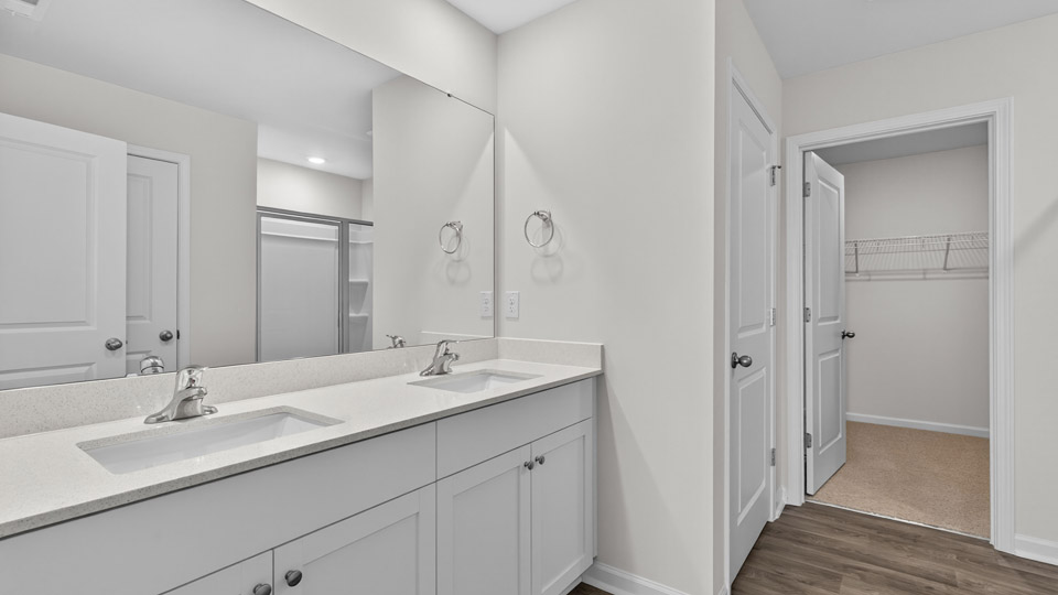 Primary bathroom with double sink and walk-in shower