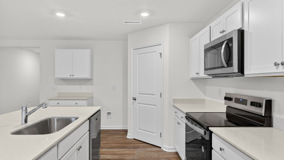 kitchen with white cabinets and quartz countertops