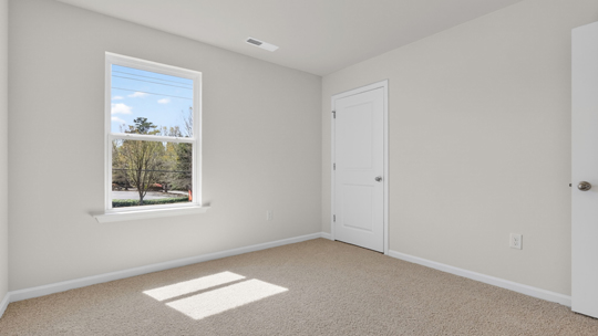 secondary bedroom with carpet flooring