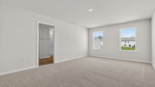 primary bedroom with carpet flooring
