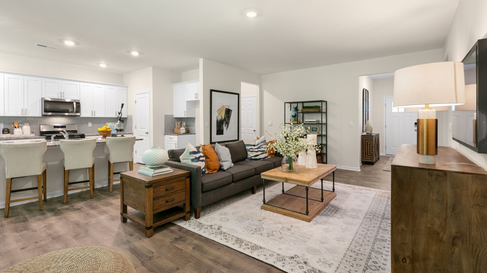 open concept living room overlooked by kitchen