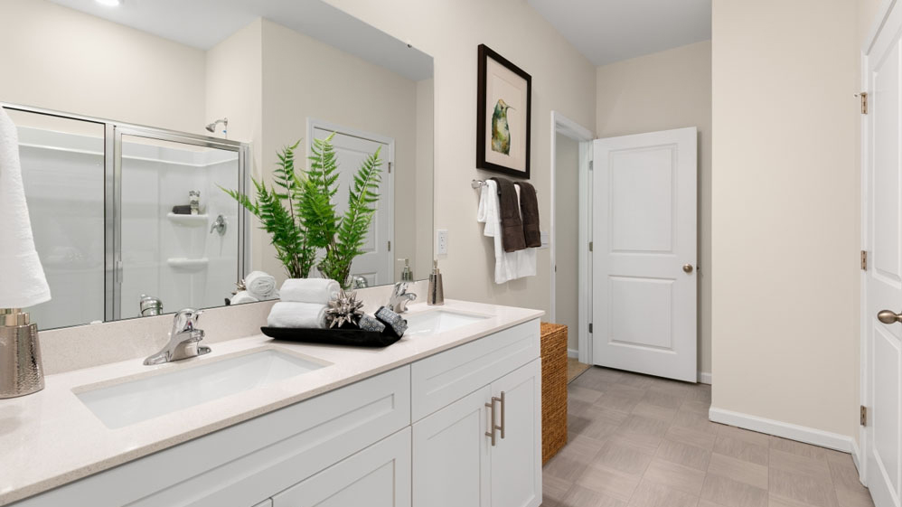 bathroom with dual vanity and white quartz countertops