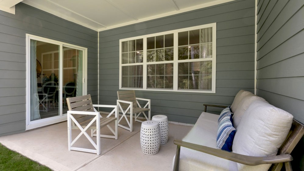 covered concrete patio with sliding glass doors