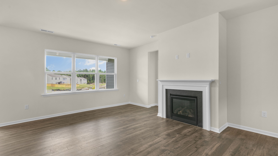 open concept living space with large windows, fireplace