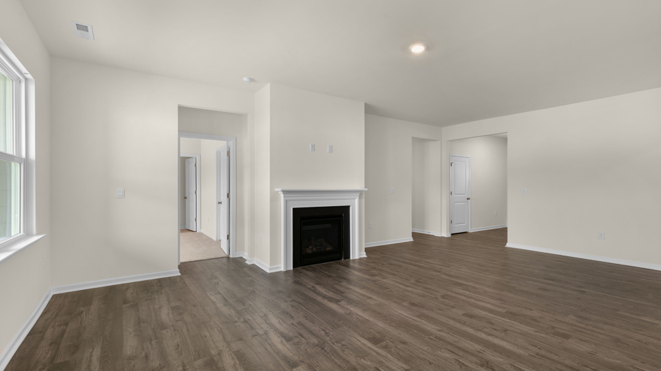 open concept living space with large windows, fireplace