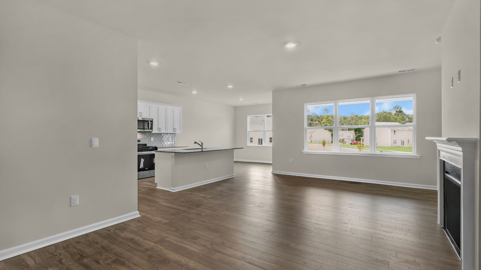 open concept living space with large windows, fireplace