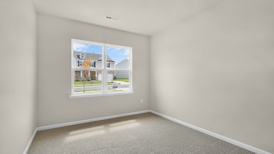 secondary bedroom with window and closet, carpeting