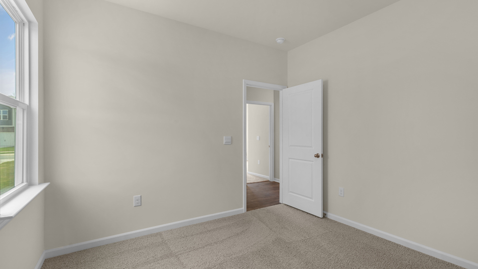 additional bedroom with window, carpeting, closet