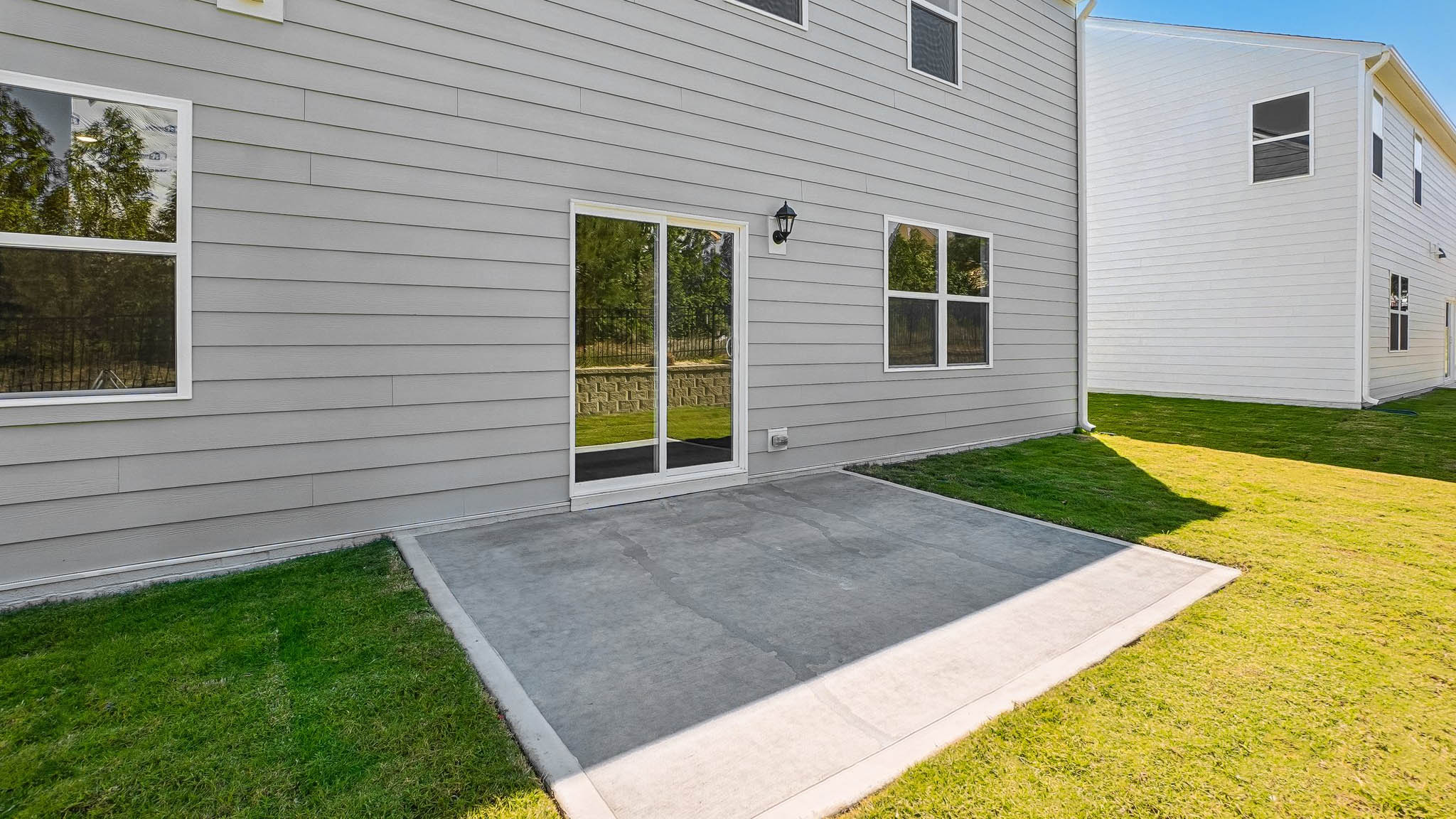 exterior patio with concrete slab and open yard