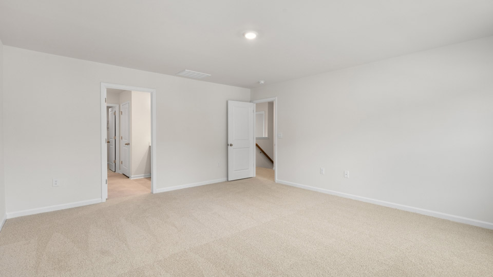 Primary bedroom with carpet flooring