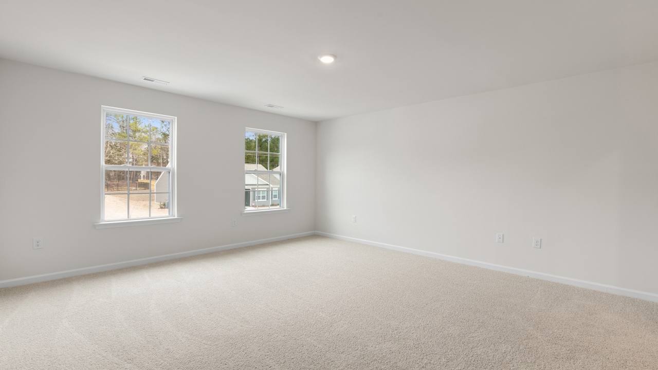 Primary bedroom with carpet flooring