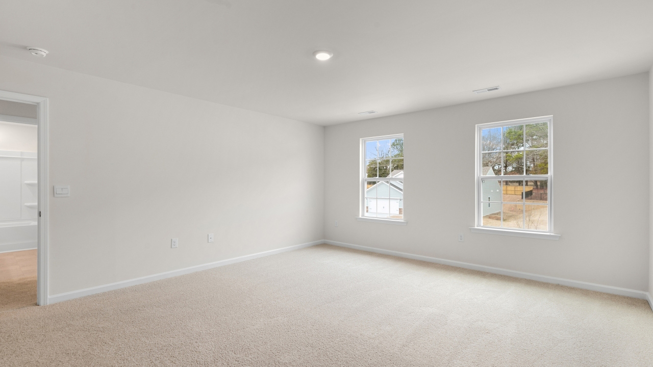 Primary bedroom with carpet flooring