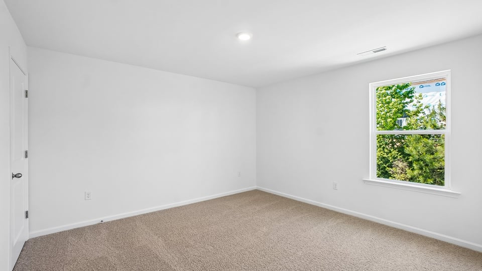 secondary bedroom with window and closet, carpeting