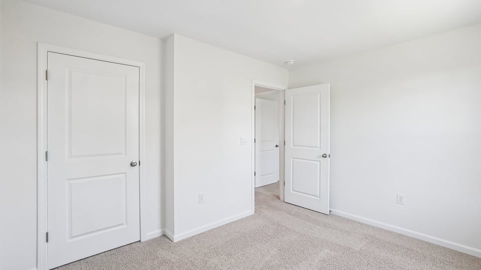 additional bedroom with window, carpeting, closet