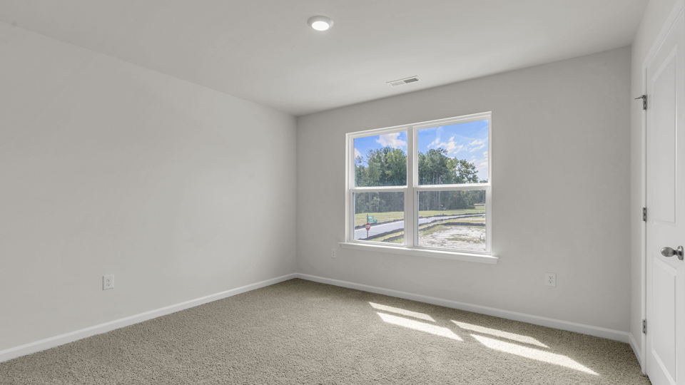 additional bedroom with window, carpeting, closet