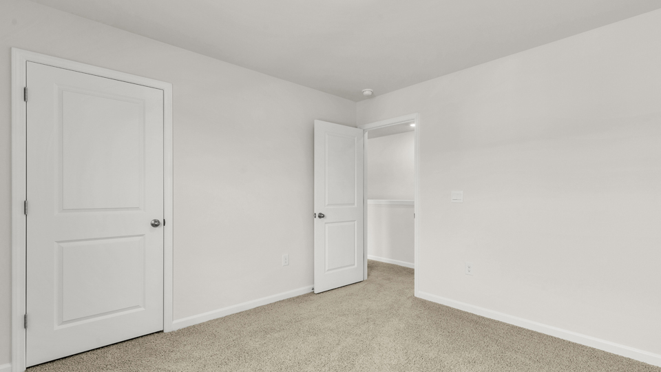 additional bedroom with window, carpeting, closet