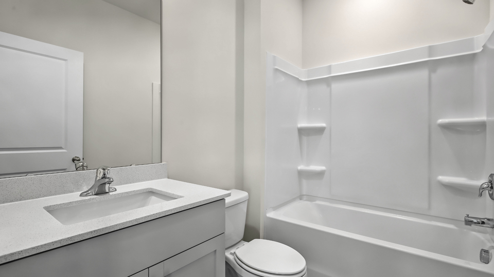 secondary bathroom with shower tub combo and single vanity sink