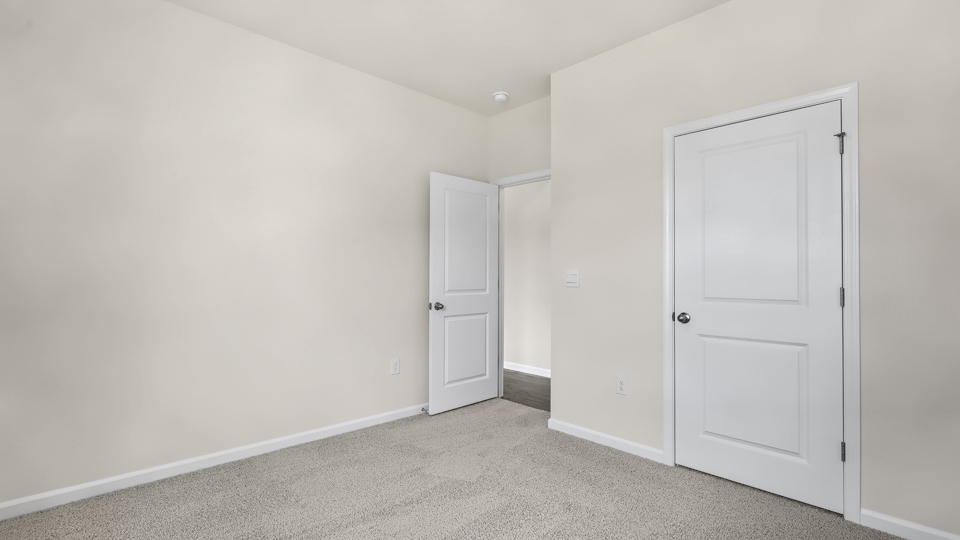 secondary bedroom with window and closet, carpeting