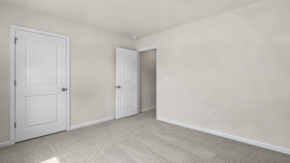 additional bedroom with window, carpeting, closet
