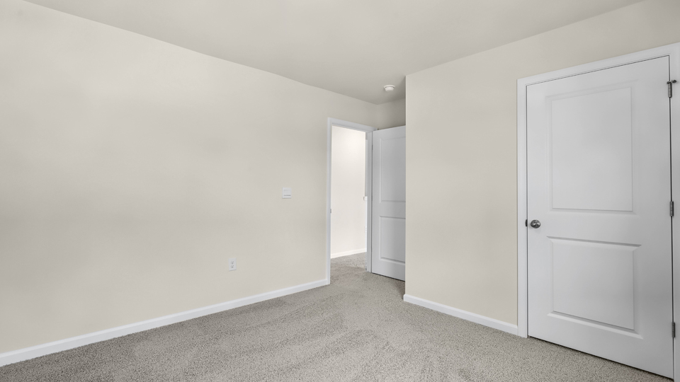 additional bedroom with window, carpeting, closet