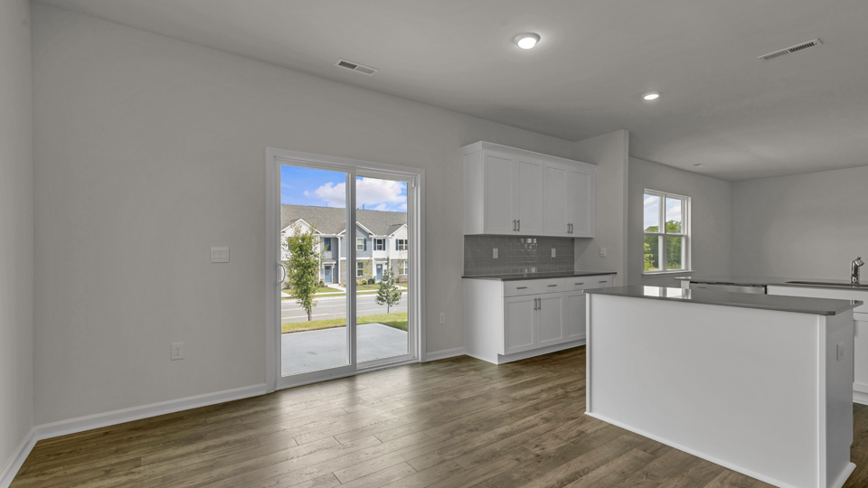 open concept dining space with sliding glass door to patio