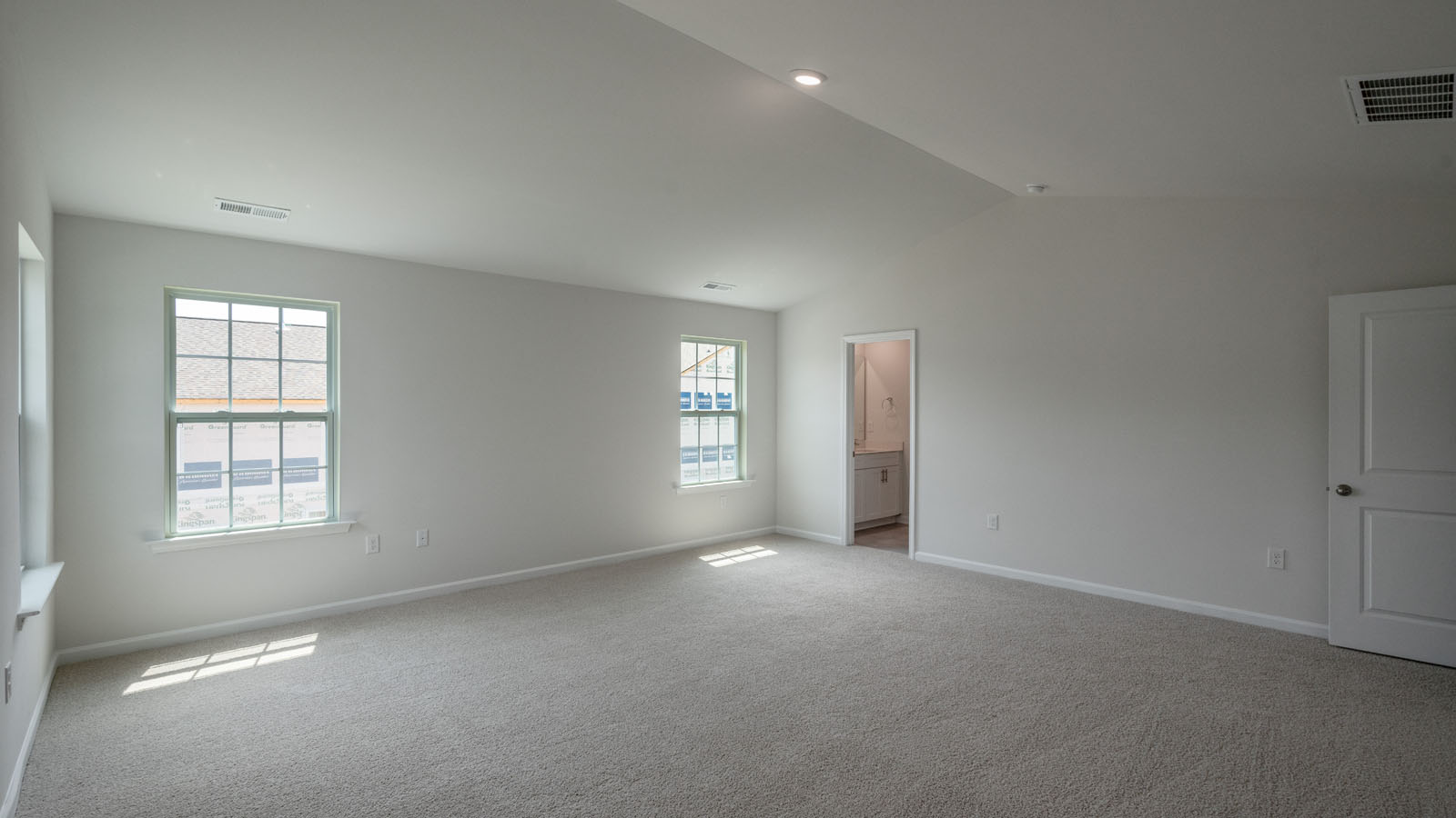 Primary bedroom with carpet flooring