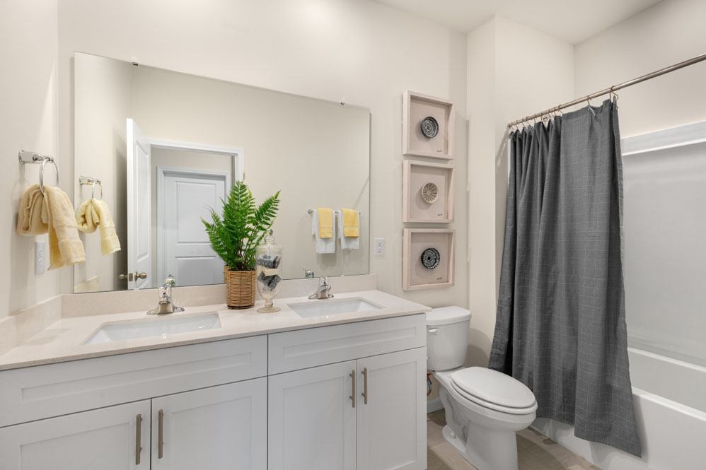 secondary bathroom with shower tub combo and single vanity sink