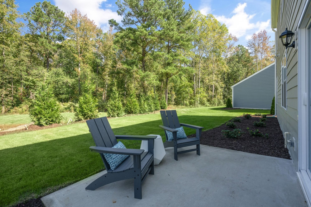 exterior patio with concrete slab and open yard