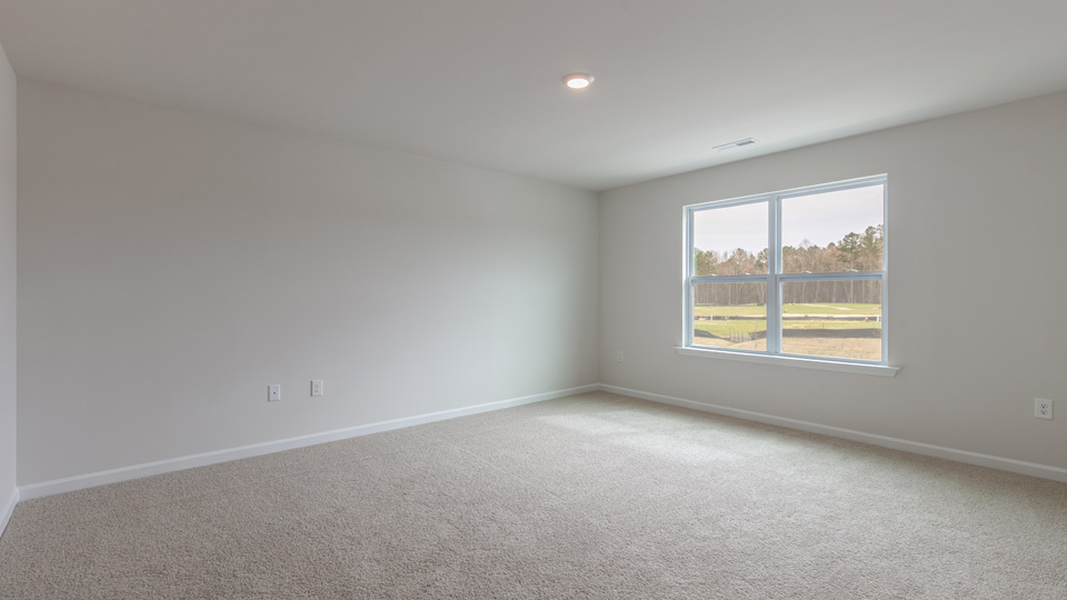 Primary bedroom with carpet flooring