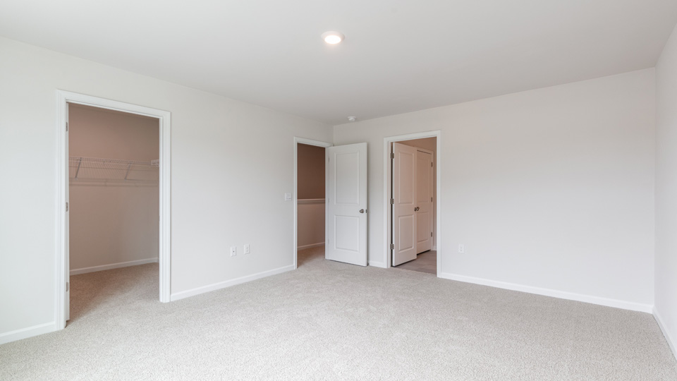 Primary bedroom with carpet flooring