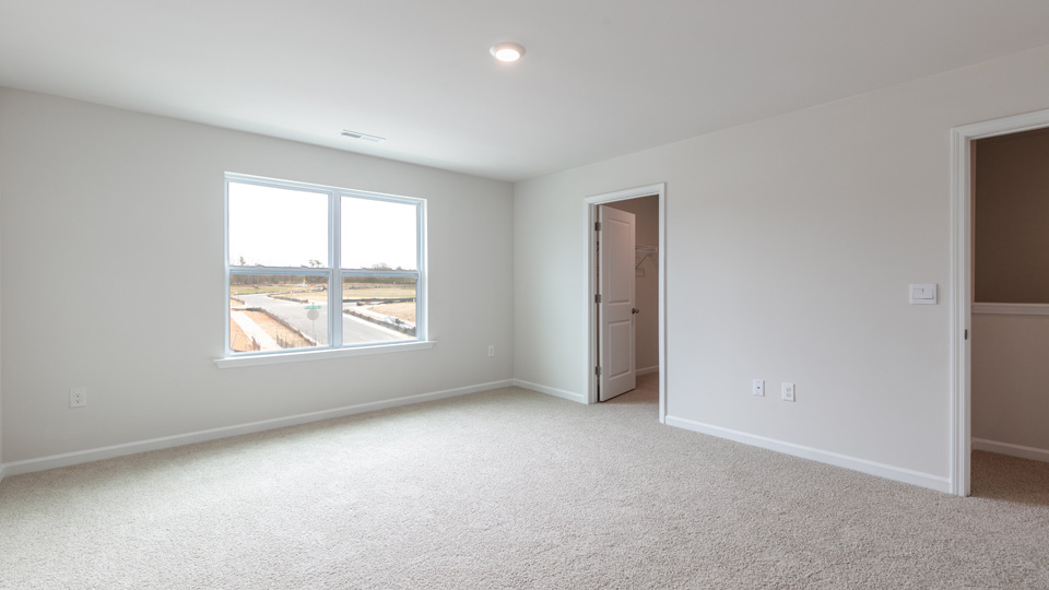 Primary bedroom with carpet flooring
