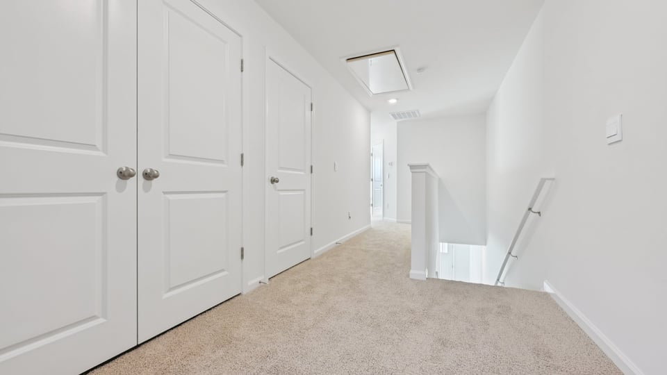 Upstairs hallway with carpet flooring
