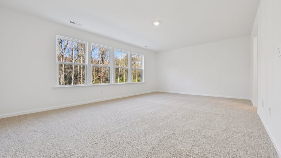 Primary bedroom with carpet flooring