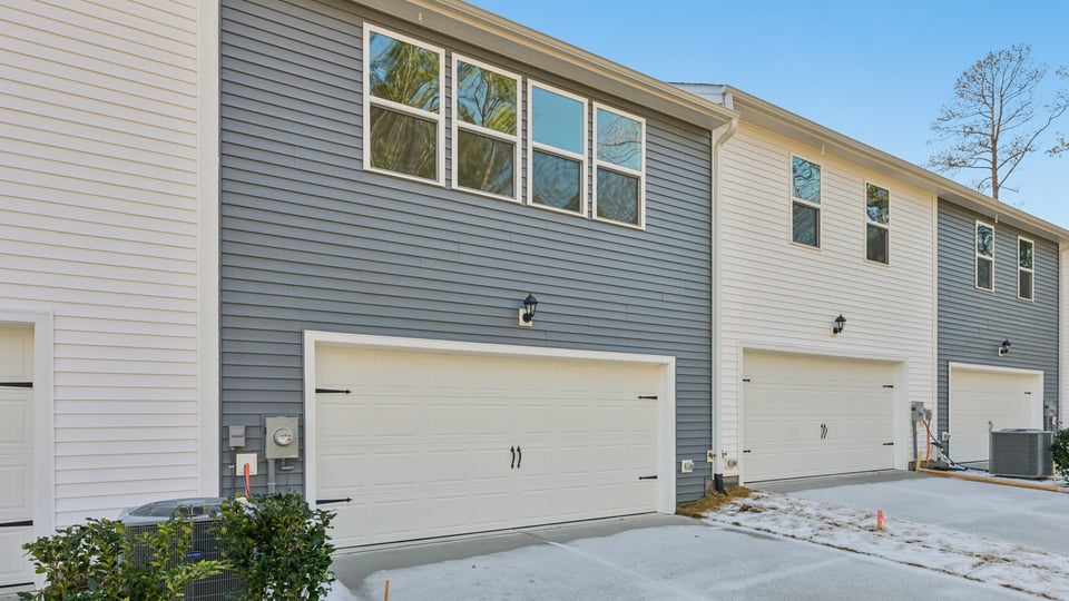 Two story town home with blue siding.