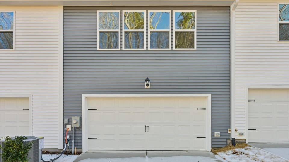 Two story town home with blue siding.