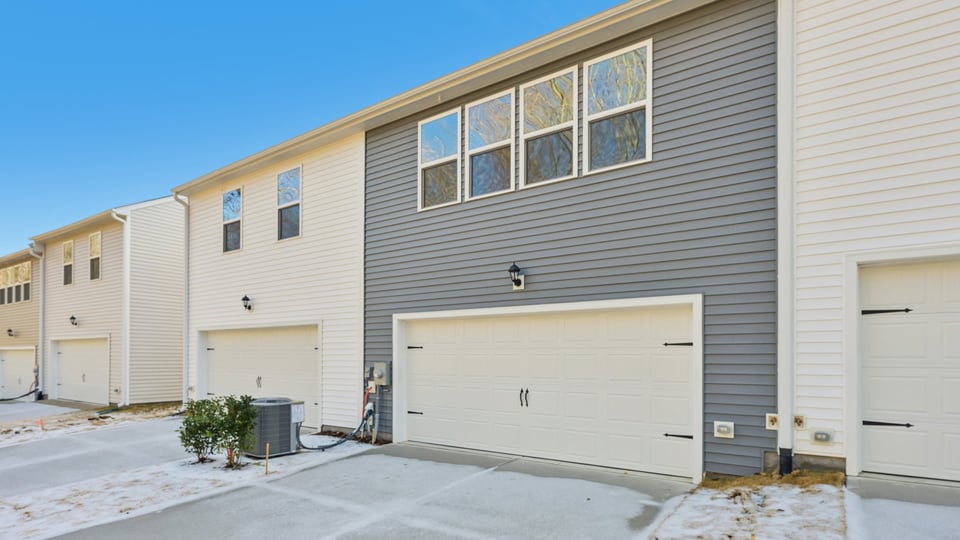 Two story town home with blue siding.