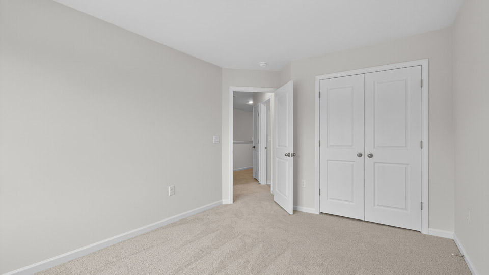 additional bedroom with window, carpeting, closet