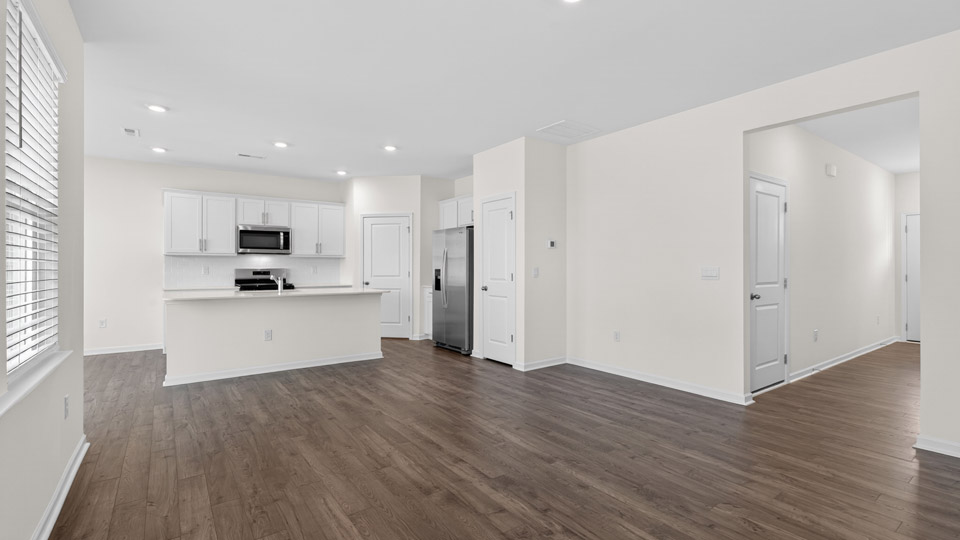 Open-concept living room leading to kitchen